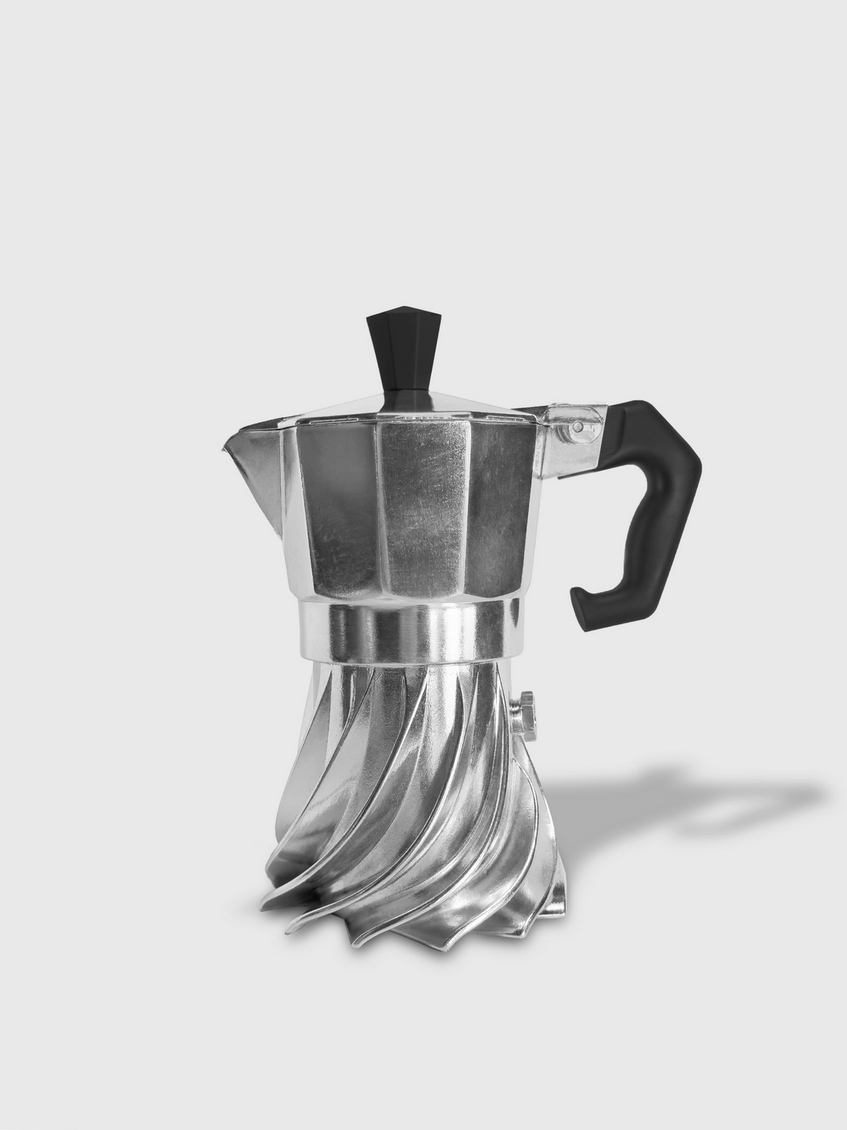 Black and white studio photograph of the Turbo Moka 1-cup aluminium moka pot on a plain grey background, showing the turbine-finned base and black handle