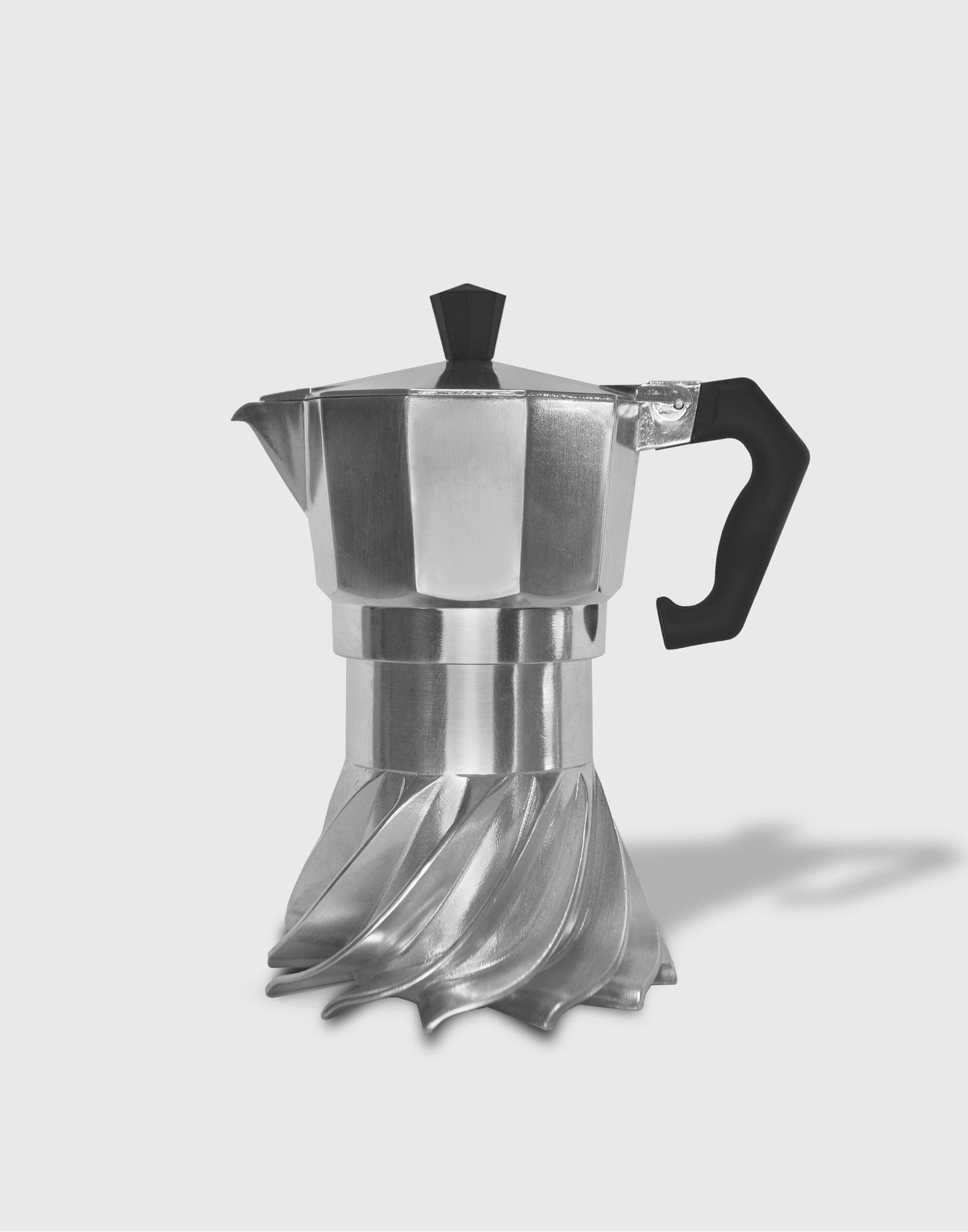 Black and white studio photograph of the Turbo Moka 3-cup aluminium moka pot on a plain grey background, showing the twisted turbine fins of the base