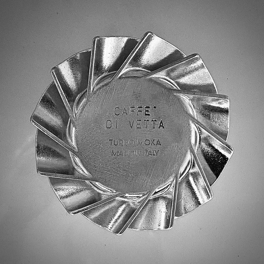 Underside of a Turbo Moka turbine base engraved Caffe di Vetta above Turbo Moka Made in Italy, an example of custom engraving