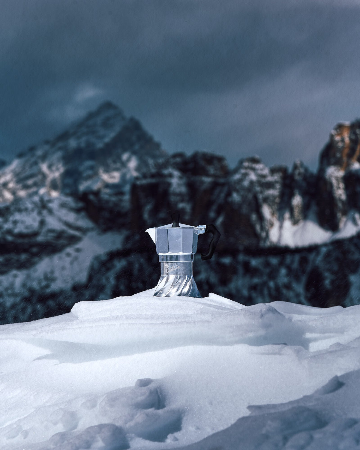 Turbo Moka Cortina Edition standing in a snowdrift with the Dolomite peaks behind