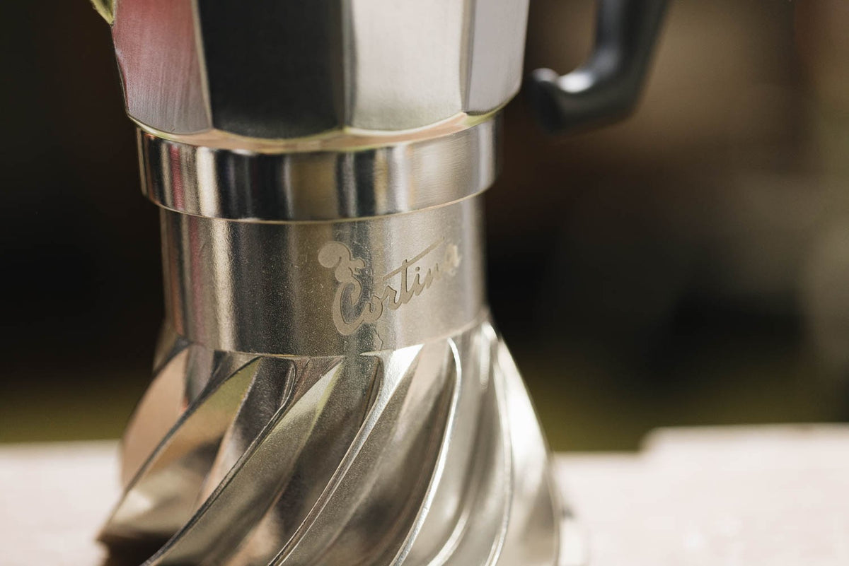 Close-up of the Cortina script engraving on the polished collar of the Turbo Moka, just above the turbine fins