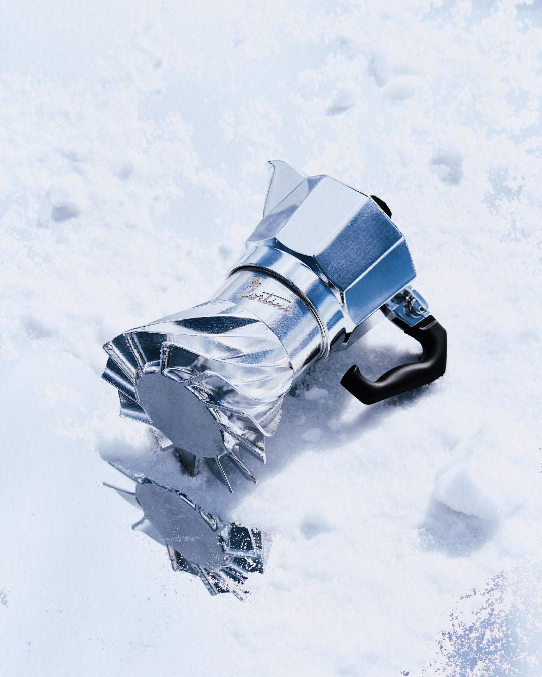 Turbo Moka Cortina d'Ampezzo Edition lying on fresh snow, the Cortina script engraving visible on the polished collar