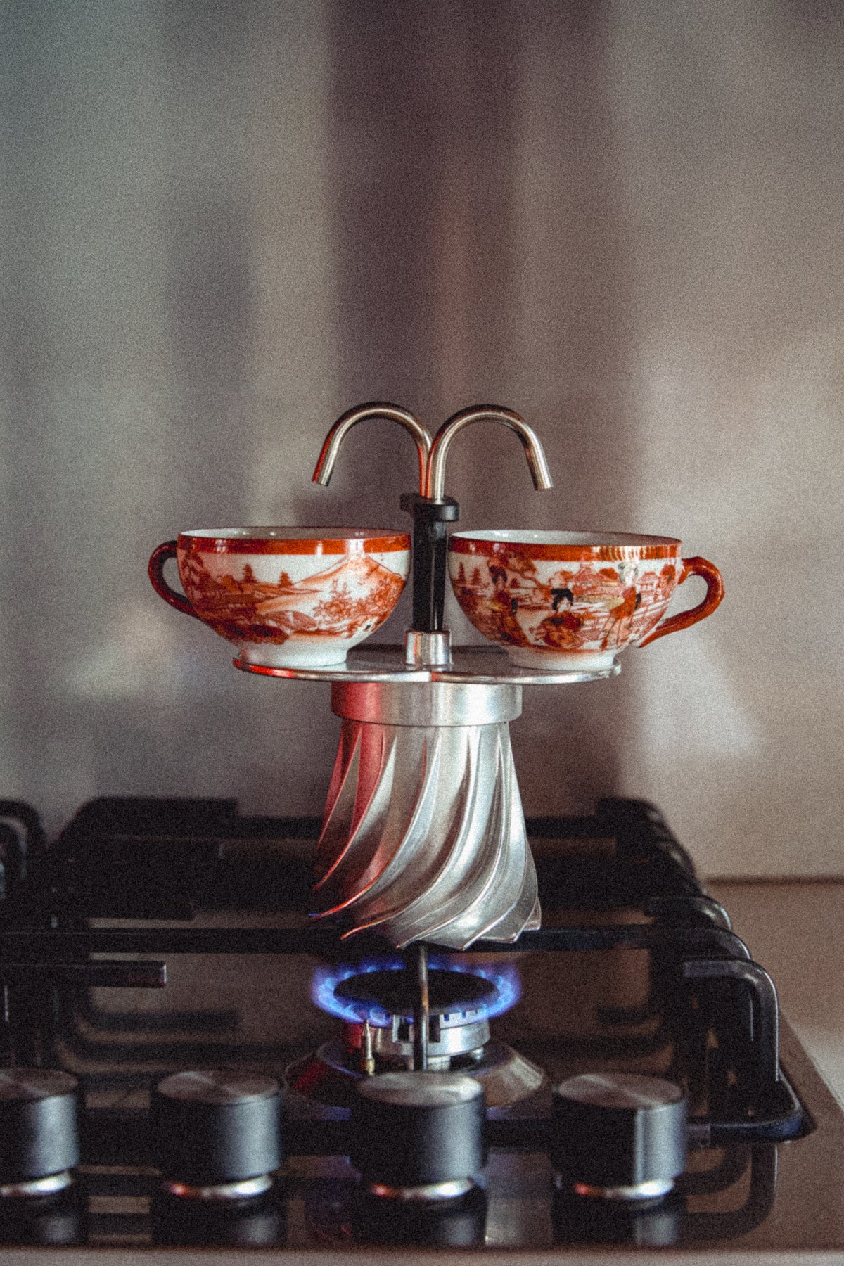 Turbo Moka Duetto brewing on a gas hob, coffee running through both spouts into two cups